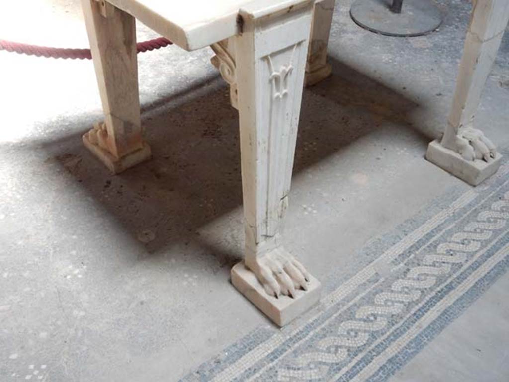 V.4.a Pompeii. May 2015. Marble table legs at edge of impluvium. Photo courtesy of Buzz Ferebee.