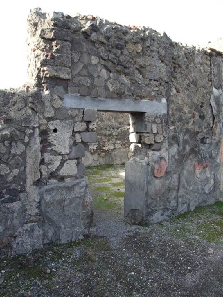 VI.1.7 Pompeii. December 2007. Doorway to room 10, from atrium, looking north-west.
This room was reported as being excavated on the 22nd July 1784 (see PAH 1, 2, (p.21-22), and 29th July 1794, and Addenda (p.166-167).
ADDENDA, (p.166-167)
22 July 1784 Si scoprono due stanze appartenenti alla terza abitazione vicino alla Porta di pompei, nel lato settentrionale. Questa era qualla che va sotto il nome delle Vestali. 
Curioso musaico di vetri e pastiglie in una della suddette stanze, con uno specchio in mezzo. Questa camera pare che fosse addetta all’uso di mangiare, ossia un triclinio.
29 July 1784
Musaico con due delfini, ed in mezzo di essi un’ancora, che orna la soglia della porta piu grande d’ingresso al suddetto triclinio.
(translation – 
22ND July 1784 Two rooms belonging to the third dwelling near the Gate of Pompeii on the north side, were excavated. This was the one that goes by the name of the Vestals.  
A curious glass and paste mosaic was found in one of these rooms, with a mirror(?) in the middle.  This room seems to have been used for eating, i.e. a triclinium. 
29th July 1784
Mosaic with two dolphins, and between them an anchor, which adorned the largest door threshold at the entrance to the aforementioned triclinium.
