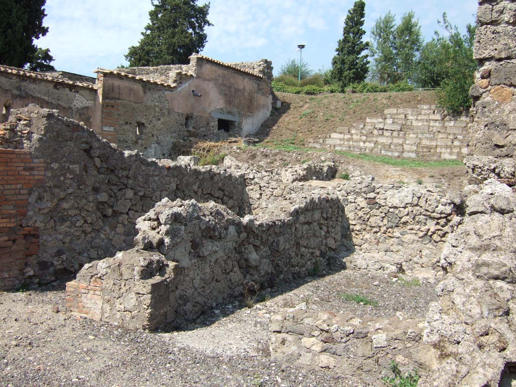 VI.2.17 Pompeii. September 2005. Two rooms on north side of atrium.
On the left is the site of stairs to upper floor, and the entrance to a triclinium, is on the right.   
See Eschebach, L., 1993. Gebäudeverzeichnis und Stadtplan der antiken Stadt Pompeji. Köln: Böhlau. (p.159)
