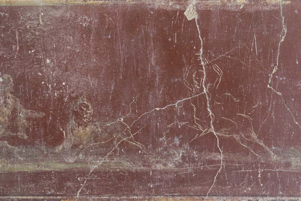 VI.8.3/5 Pompeii. April 2022. 
Room 12, detail of continuation of part of hunt scene with centaurs and a lion, from red predella below central panel on south wall.
Photo courtesy of Johannes Eber.
