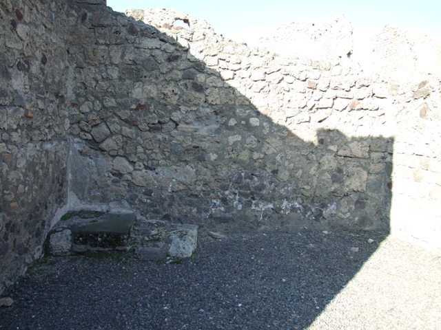 VI.14.14.  North wall of shop.  Stone base of wooden staircase to upper storey.