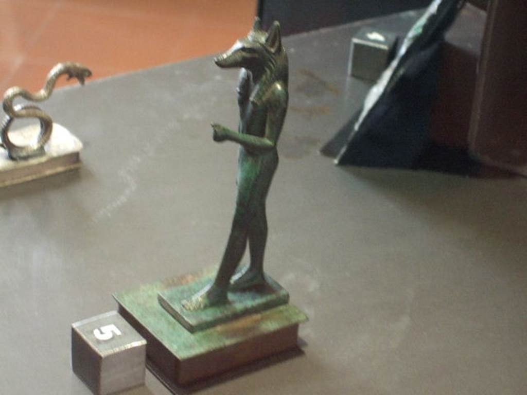 VI.14.27 Pompeii Found in room b, a bronze statuette of the dog faced Egyptian god Anubis.  
Now in Naples Archaeological Museum. Inventory number 110606.
