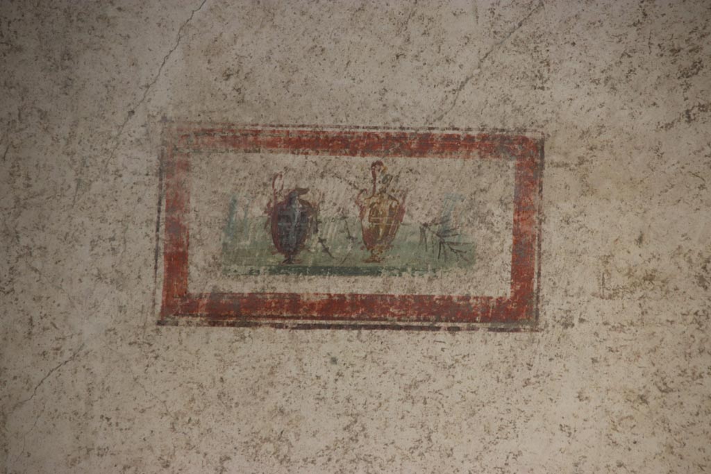 VI.15.1 Pompeii. October 2023. Detail of painted panel at west end of north wall. Photo courtesy of Klaus Heese.