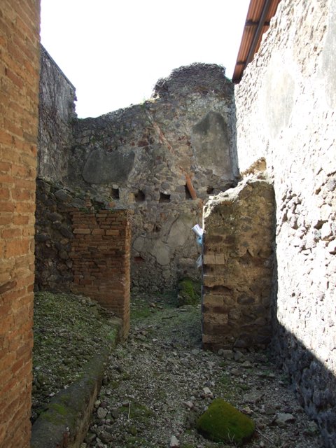VI.15.9 Pompeii.  March 2009.  Kitchen area, doorway through to kitchen and latrine. Looking west.