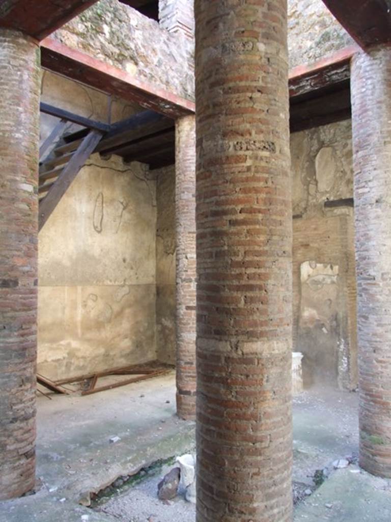 VI.15.9 Pompeii. March 2009. Looking south-west across atrium. Brick columns around impluvium, supporting upper floor. 
