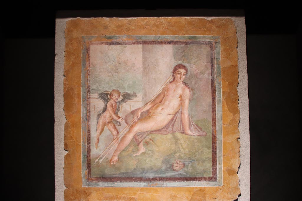 Insula Occidentalis, Pompeii. October 2022. 
Narcissus looking at his reflection in the water with a cherub at his side. Photo courtesy of Klaus Heese. 
Photographed in an exhibition in the Palaestra 2022.
The information card at the exhibition only said –
“Narcissus looking at his reflection in the water and a cherub. Fresco, 1st century AD, Pompeii, Insula Occidentalis.”  
According to Mastroroberto –
This painting of Narcissus (76 x 73 cms) may have the inventory number 17739.
See Pompei - Picta Fragmenta, exhibition catalogue 1997-98 curated by P.G. Guzzo, (p.122, no.74).
