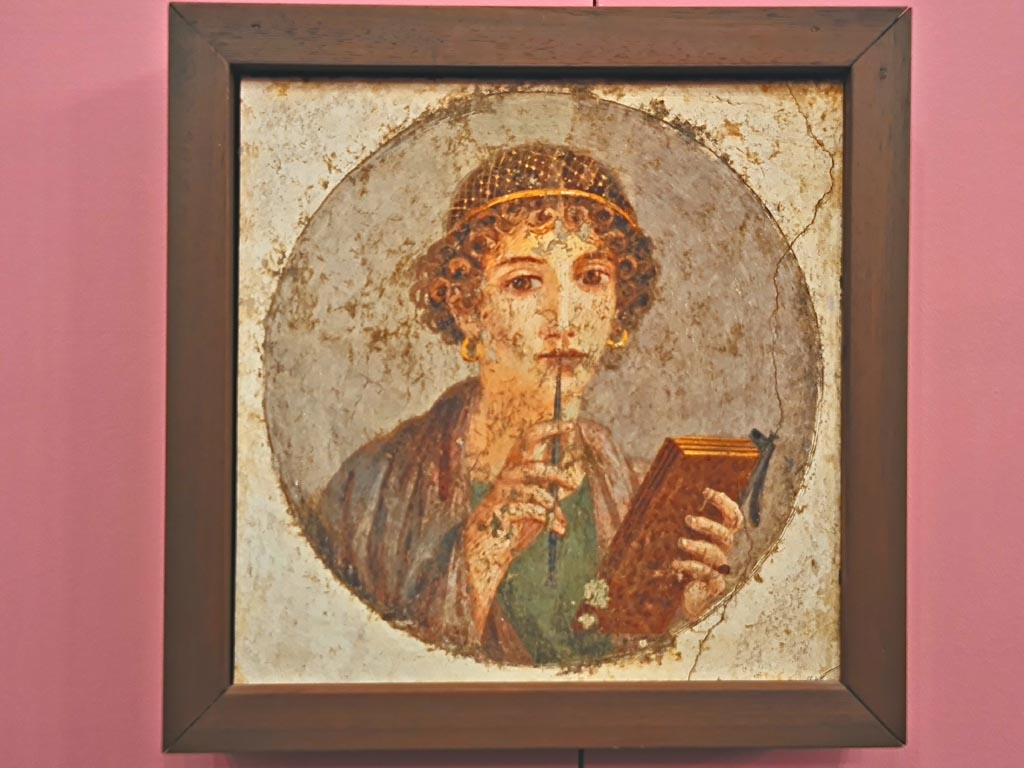 Pompeii Insula Occidentalis. October 2023. 
Sappho or young woman with tablet and stylus, found beneath the Cuomo property on17th May 1760. 
On display in “L’altro MANN” exhibition, October 2023. Photo courtesy of Giuseppe Ciaramella.
