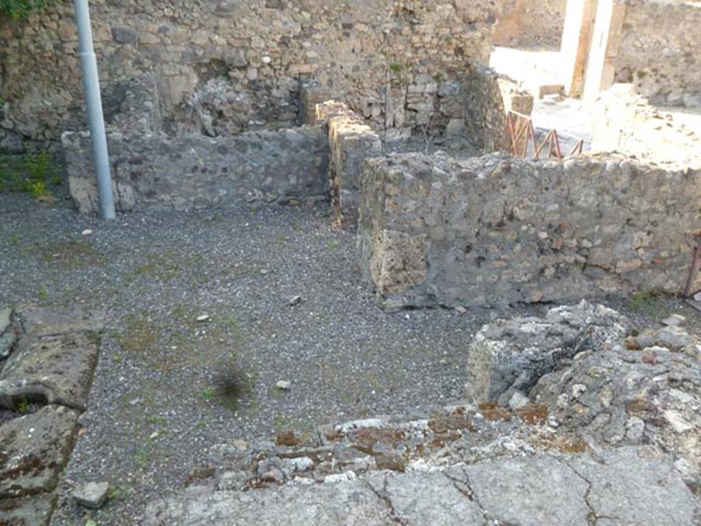 VI.17.16 Pompeii. May 2011. Looking towards north-east corner of atrium. In the centre right, the doorway into the shop at VI.17.15 can be seen, together with its rear room and its entrance doorway. The entrance corridor of VI.17.16 leading out onto Via Consolare can be seen on the right. 

