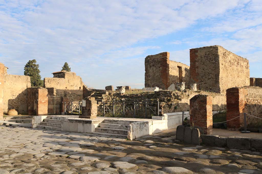 VII.4.1 Pompeii, on left, with VII.4.2, in centre.December 2018. 
Looking north-east on Via del Foro towards steps to Temple. Photo courtesy of Aude Durand.
