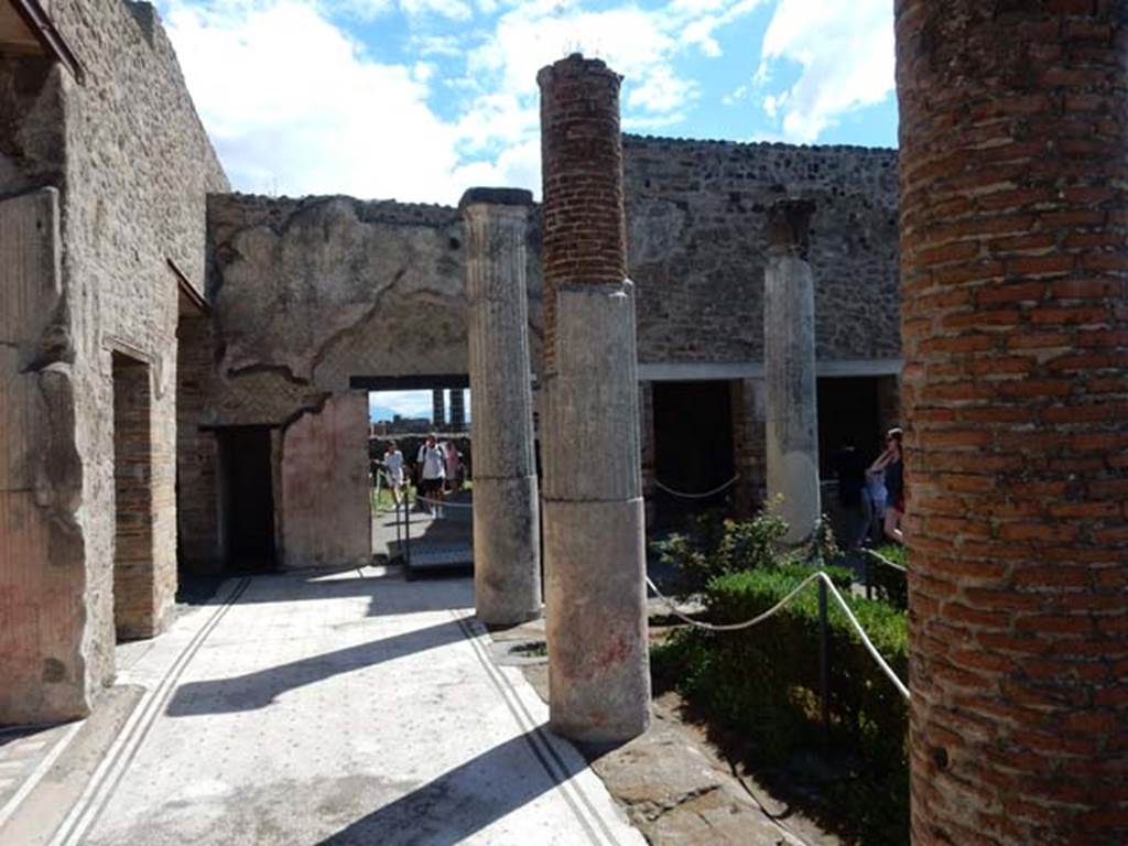 VII.7.5, Pompeii. May 2018. Looking east along north portico. 
On the left, north side, after the “open doorway” of the exedra, is the doorway to corridor (r) leading to the rear entrance at VII.7.14, followed by the doorway to room (q).
Ahead, on the east side, is the linking doorway to the south portico of VII.7.2.
Photo courtesy of Buzz Ferebee.
