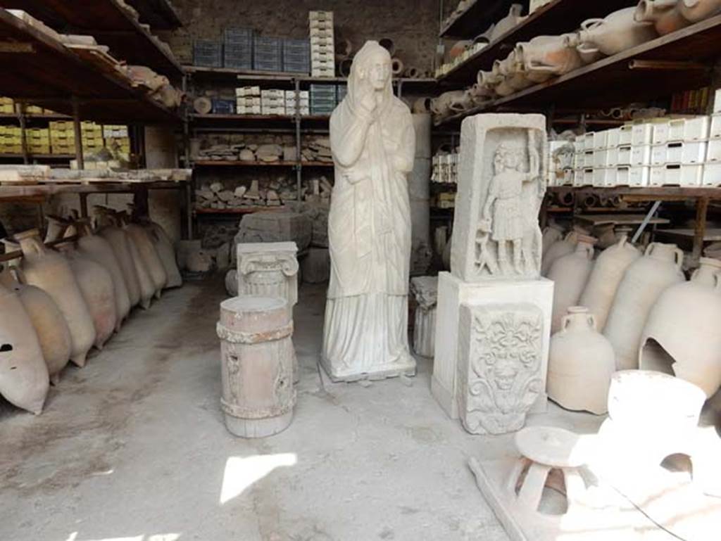 VII.7.29 Pompeii. May 2015. Barrel, plaque, female statue and rectangular sculpture of Dionysus with panther in storage. Photo courtesy of Buzz Ferebee.