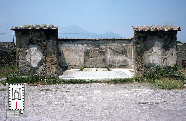 VII.7.32 Pompeii. June 1979 photo of the ruined cella (cult chamber) of the Temple of Apollo, Pompeii. The walls are preserved to only a fraction of their height, and are now protected by modern tiles. The floor was paved with white and black stone in a manner datable to the mid second-century BCE (the early date also indicated by an Oscan inscription that names the quaestor Oppius Campanus, not visible here). Just off to the left, inside the cella wall part of the ovoid stone, or omphalos (the navel) sacred to Apollo is visible. The base for the cult statue survives at the back of the cella (the statue was not found). The stucco covering of the walls is fairly well preserved inside the cella walls, and represents upright orthostats of faux marble . . . an indicator of the so-called First style of Campanian wall decoration (and another indicator of the date of the structure). The door jambs are of Sarno limestone; the cella walls constructed elsewhere of rubble masonry and concrete. 
The temple was probably awaiting reconstruction in 70 CE, having been damaged in the earthquake of 62 CE. This photo was taken in 1979 when public access to the temple was permitted. Photo Courtesy of Roger B. Ulrich. See http://www.dartmouth.edu/~rogerulrich/images.html