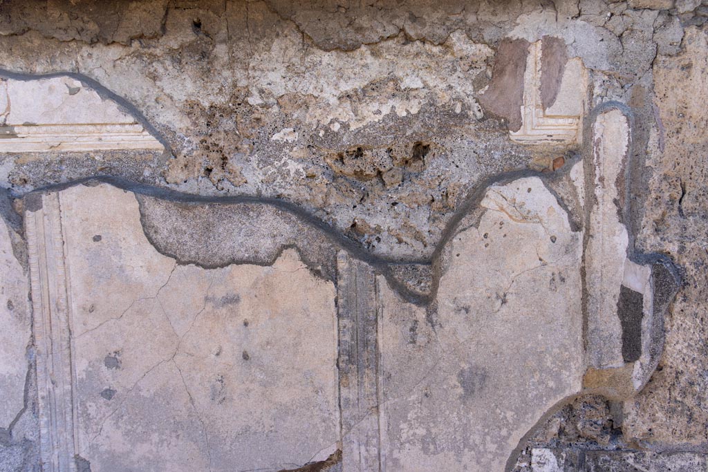 VII.7.32 Pompeii. October 2023. Detail of north side of cella, at west end. Photo courtesy of Johannes Eber.