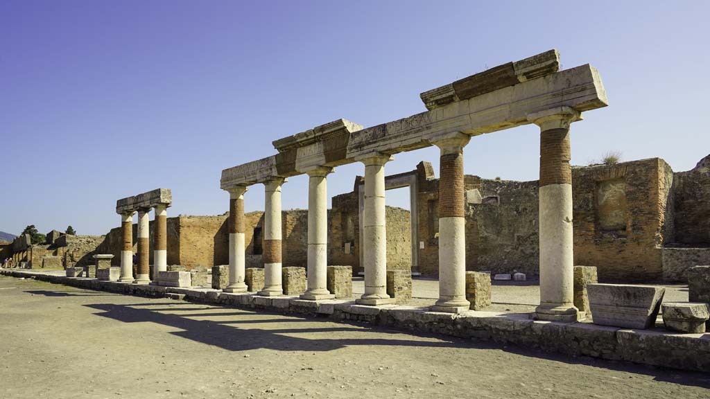 VII.8 Pompeii Forum. August 2021. 
Looking east across Forum towards the building of Eumachia’s portico. Photo courtesy of Robert Hanson.
