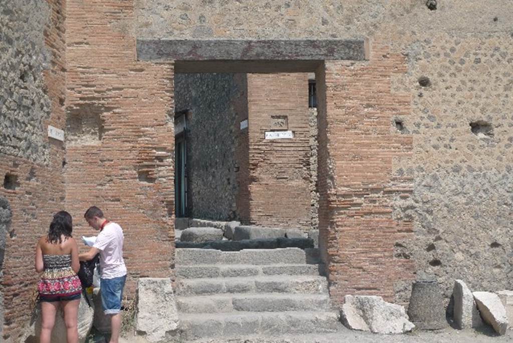 VII.8 Pompeii Forum. July 2010. Steps and doorway on west end of the north wall of the Forum. Photo courtesy of Michael Binns.