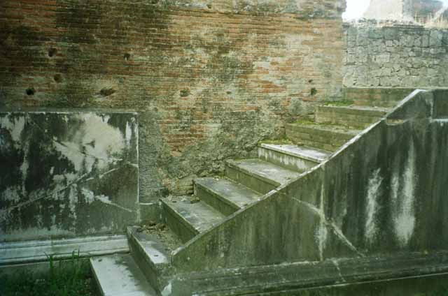 VII.9.2 Pompeii, May 2018. Steps to cella on north side, remaining decoration. Photo courtesy of Buzz Ferebee.