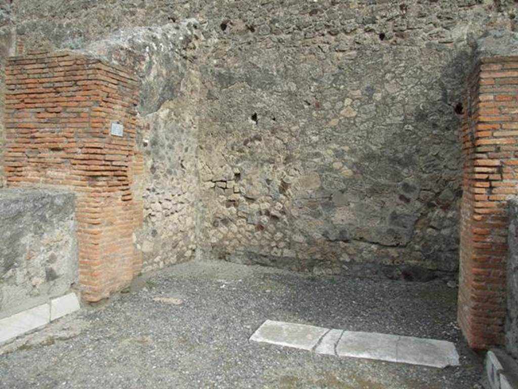 VII.9.5 Pompeii. December 2007. Remains of marble plinths on two statue bases either side of shop, on left and right.
