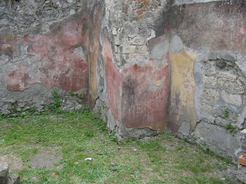 VII.12.15 Pompeii. May 2003. South-west corner of triclinium/rear room. 
The remaining painted walls would appear to show alternating red and yellow panels. Photo courtesy of Nicolas Monteix
