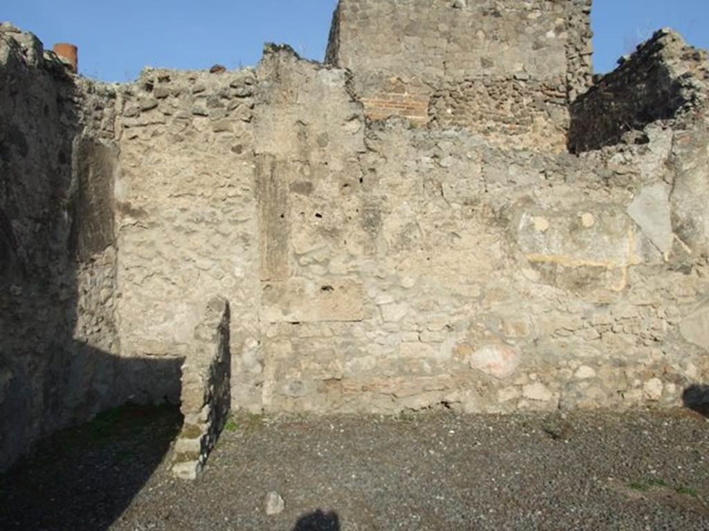 VII.13.5 Pompeii. December 2007. North wall of shop. At the rear, on the left, can be seen the latrine with a down-pipe from above.
