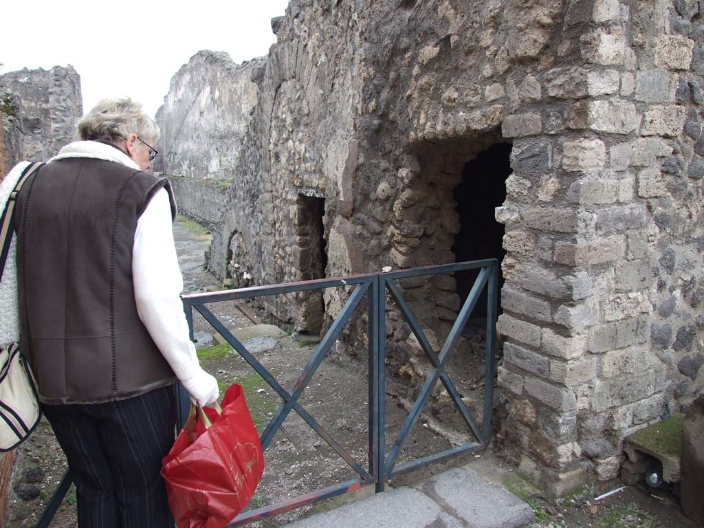 VIII.1.7 Pompeii. December 2007. Looking west along Vicolo di Championnet showing entrances under the stone stairs.