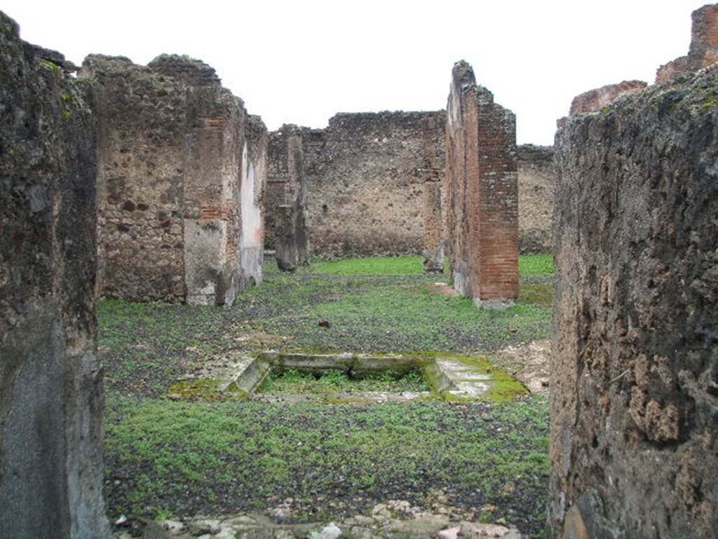 VIII.2.13 Pompeii. December 2004. 
Looking west from entrance to atrium with impluvium and pseudo-peristyle, at rear.
According to Jashemski, the garden at the rear of the tablinum was enclosed on the east and south by a portico supported by columns.
See Jashemski, W. F., 1993. The Gardens of Pompeii, Volume II: Appendices. New York: Caratzas. (p.205).  According to Garcia y Garcia, due to the bombing in 1943 there was destruction to part of the ala on the north of the portico. Two columns of the portico also fell down.
See Garcia y Garcia, L., 2006. Danni di guerra a Pompei. Rome: L’Erma di Bretschneider. (p.139)

