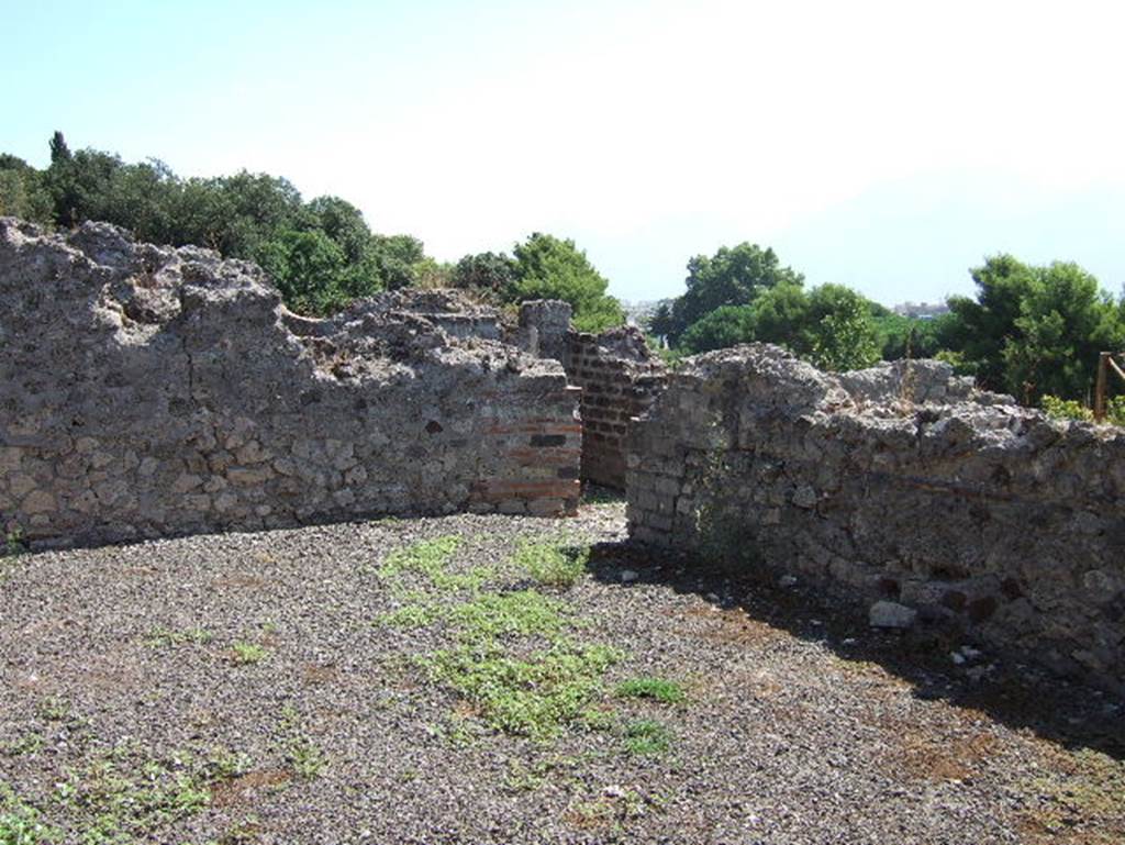 VIII.2.30 Pompeii. September 2005. Looking east across large room on east side of tablinum. In the centre can be seen a doorway leading to a corridor, and stairs to rooms below.
