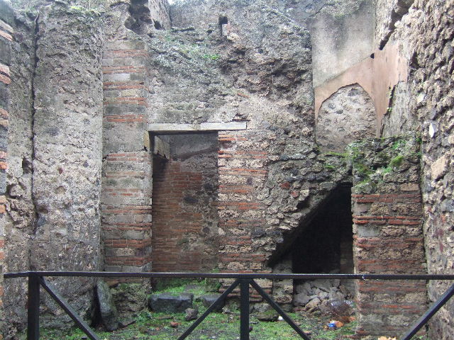 VIII.2.38 Pompeii. December 2004. Looking south to doorway to Kitchen and Steps to upper floor, with recess below.

