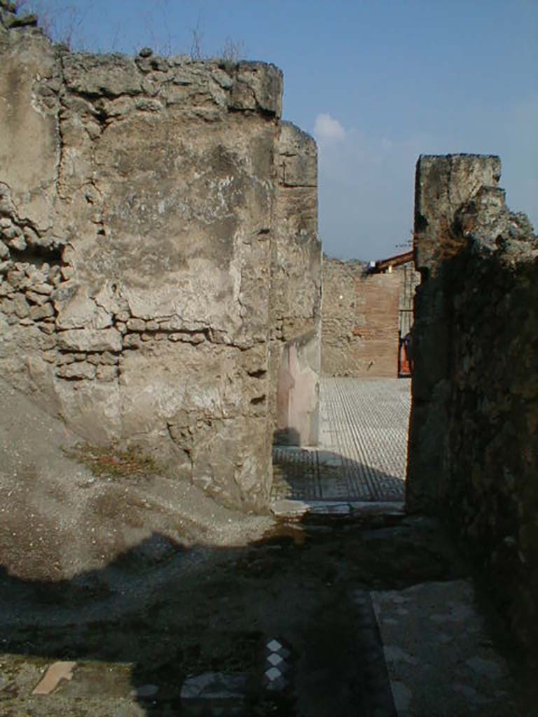 VIII.3.8 Pompeii. September 2004. North wall of oecus, with doorway to atrium.
The floor of this room was formed by diamonds of limestone tiles belonging to a most ancient floor, which was edged by a high fascia of white mosaic tiles.
