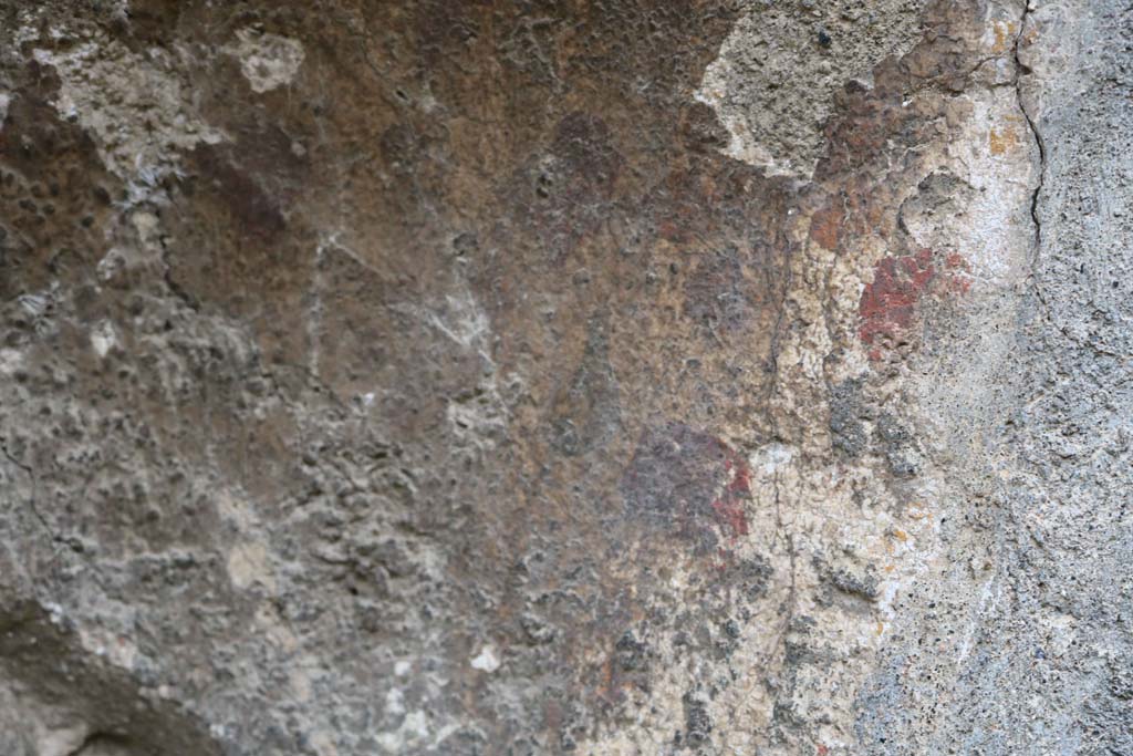VIII.4.12, Pompeii. December 2018. 
Detail of remaining plaster in niche, red and yellow flowers, perhaps. Photo courtesy of Aude Durand.
