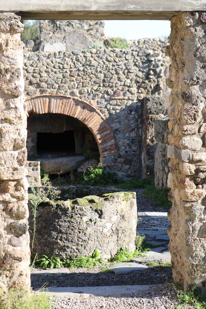 VIII.6.11, Pompeii. December 2018. 
Looking east through doorway from room f or stable, towards bakery. Photo courtesy of Aude Durand.
