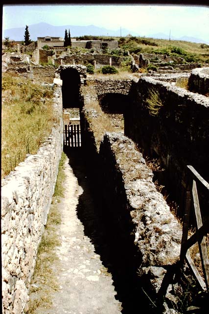 VIII.7.21 (on left) and VIII.7.20 (centre). Pompeii. June 1962.  Looking east from entrance corridors towards Reg. 1, insula 3. Photo courtesy of Rick Bauer.
