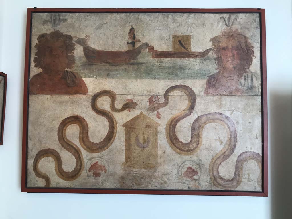 VIII.7.28 Pompeii. April 2019. Found on north wall of the sacrarium. 
Ship of Isis, transporting Osiris, and busts of river (Nile?) gods. 
Two serpents are moving towards a basket which has a crescent moon symbol on it.
Now in Naples Archaeological Museum. Inventory number 8929. Photo courtesy of Rick Bauer.
