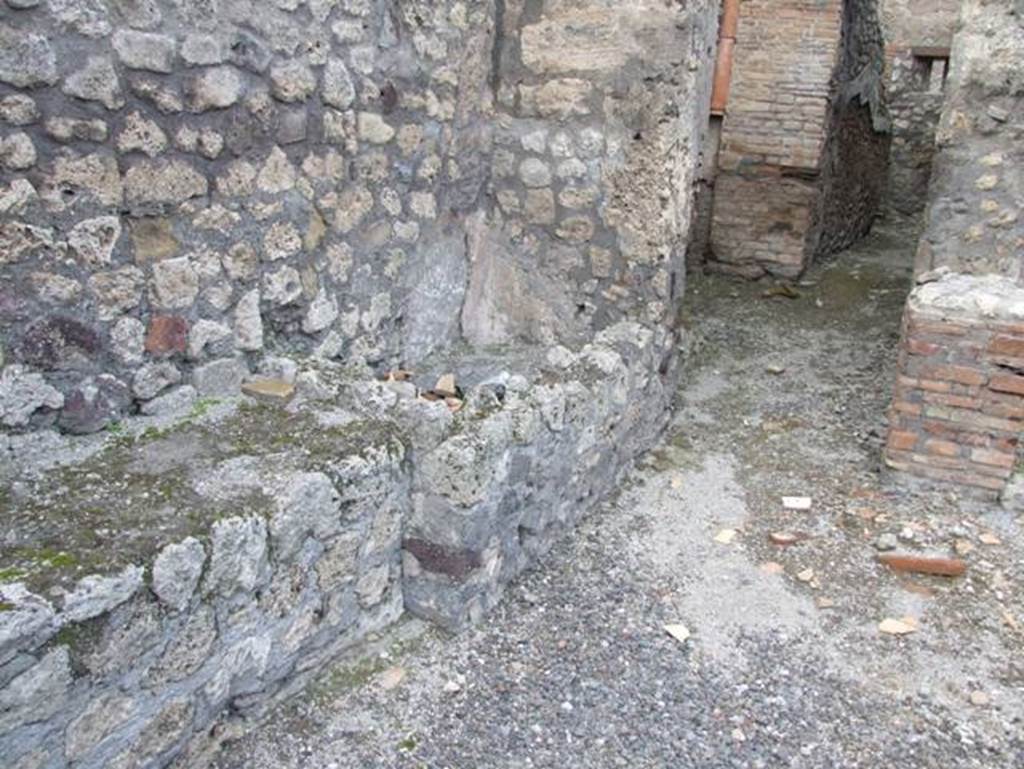 IX.3.17  Pompeii.  March 2009.  West side of workshop.   Remains of bench with water basin.