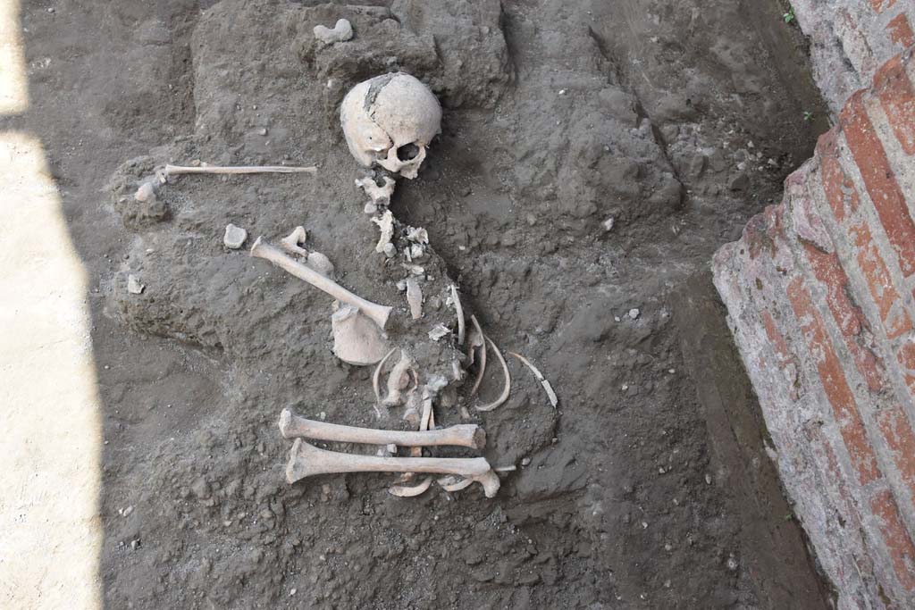 IX.4.18 Pompeii. 2018. Discovery outside room "n" of the skeleton of a child. Photograph © Parco Archeologico di Pompei.