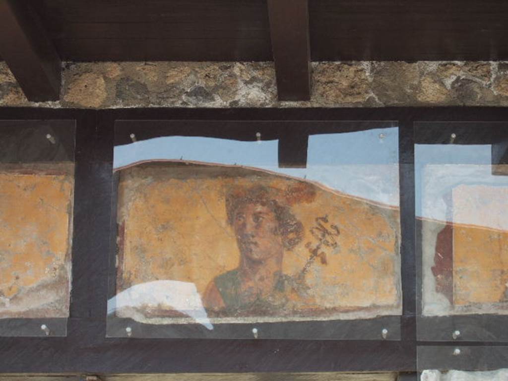 IX.7.1 Pompeii. May 2006.  Painting of Mercury with a red Petasos and the Caduceus on his left shoulder.  See Fröhlich, T., 1991, Lararien und Fassadenbilder in den Vesuvstädten.  Mainz: von Zabern.  (F63:  p.332).