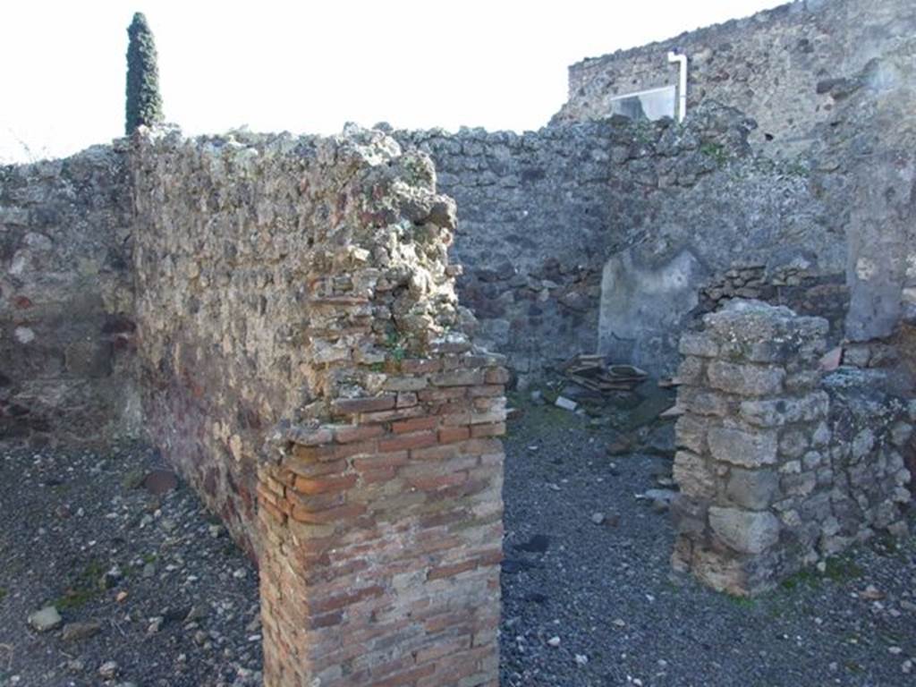 IX.9.2 Pompeii. March 2009. Doorway to room d in south-west corner of atrium. Room d was described as being a windowed cubiculum, with a window into the atrium. At the base of the pilaster between the rooms e and d was the mouth of a cistern.
