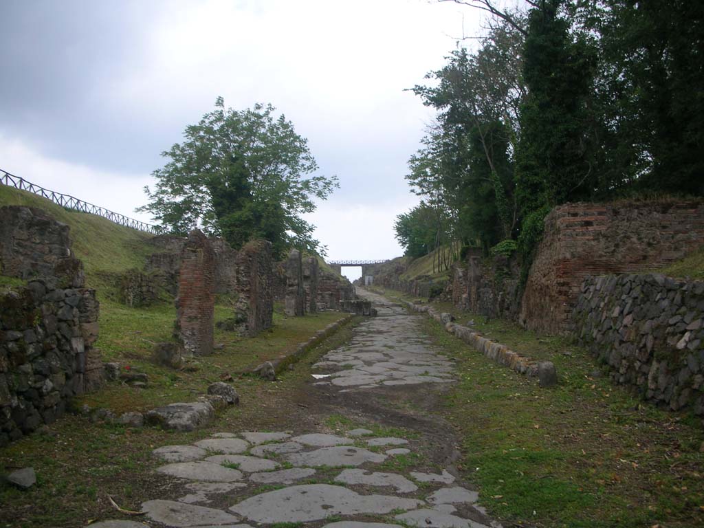 Via di Nola, Pompeii. May 2010. Looking west between III.11 and IV.5. from near the Nola Gate. Photo courtesy of Ivo van der Graaff.
. 
