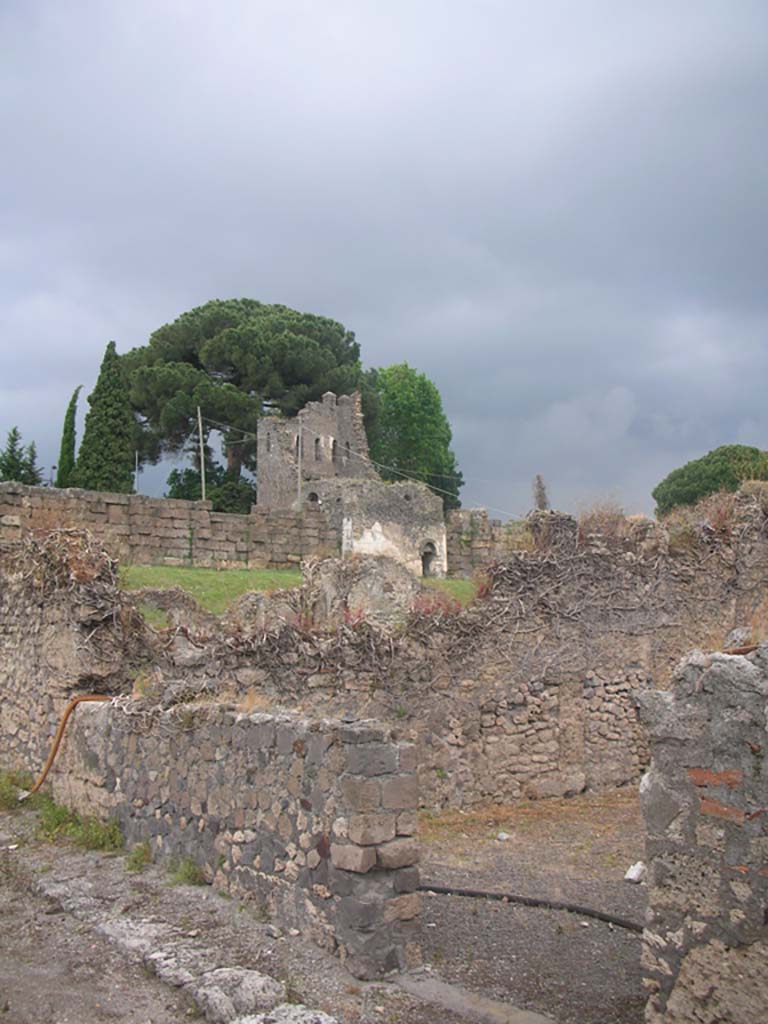 Vicolo del Fauno, Pompeii. May 2010. 
Looking north-east towards entrance to VI.11.3, and across to Tower X. Photo courtesy of Ivo van der Graaff.
