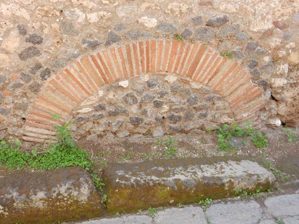 Vicolo del Gallo, Pompeii, May 2018. 
Masonry feature in south wall of roadway, in rear wall (north) side of room (v) of VII.7.10. Photo courtesy of Buzz Ferebee. 

