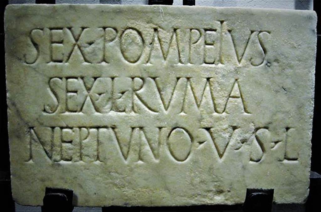 Località Case Bottaro, Tempio di Nettuno. Inscription on a marble plaque found in a wall.
Photo courtesy of Carlo Raso.
According to Fiorelli it was a small marble tablet, found outside the city.
It was found in a fondo between the mulino Bottaro, the mulino di Rosa and the old road to Castellammare
As the inscription hints near here must lie the remains of a Temple of Neptune.
See Notizie degli Scavi di Antichità, 1881, p. 121.
Now in Naples Archaeological Museum. Inventory number 111992.

   SEX· POMPEIVS
   SEX • L • RVMA
   NEPTVNO • V • S • L

According to Epigraphik-Datenbank Clauss/Slaby (See www.manfredclauss.de) this expands to

Sex(tus) Pompeius
Sex(ti) l(ibertus) Ruma
Neptuno v(otum) s(olvit) l(ibens)      [CIL X, 8157 = CIL X, 8158]

According to the Naples Museum label it was discovered in 1877. 
Location is given as Pompei, from Bottaro.
It gives the translation 
Sextus Pompeius Ruma, freedman of Sextus, willingly fulfilled his vow to Neptune.
The dedicator was possibly a freedman of Sextus Pompeus, the son of Pompey the Great, both of whose titular deities were Neptune.
Alternatively, paleographic analysis suggests, he may have been a freedman of Sextus Pompeius Proculus, a Pompeian magistrate at the time of Nero.

According to Cooley, this inscription was found outside Pompeii, towards the shore, perhaps where there was once a temple to the sea-god. 
Cooley translates this as 
Sextus Pompeius Ruma, freedman of Sextus, to Neptune, willingly fulfilled his vow.
See Cooley, A. and M.G.L., 2004. Pompeii : A Sourcebook. London : Routledge, E14, p. 89.
