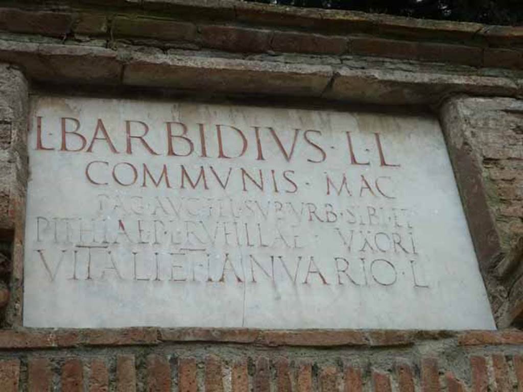 Pompeii Porta Nocera.  May 2010. Tomb 15ES. Marble plaque with Latin inscription:
L BARBIDIVS L(uci) L(ibertus)
COMMVNIS MAG(ister) 
PAG(i) AVG(usti)  FEL(icis) SVBVRB(ani) SIBI ET
PITHIAE P(ubli) L(ibertae) RVFILLAE VXORI
VITALI ET IANVARIO L(iberis).

Lucius Barbidius Communis was a freedman of Lucius Barbidius and a magistrate/priest of the Pagus Augustus Felix Suburbanus.
He constructed the tomb for himself, his wife Pithia Rufilla freedwoman of Publius Pithius, and their two sons Vitalis and Ianuarius.

