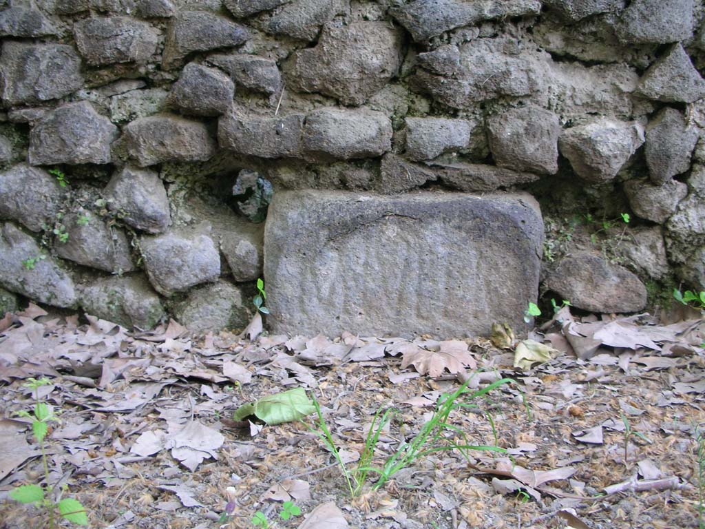 SGH Pompeii. May 2010. Front of enclosure on north side of schola with small boundary stone of M. Tullio. Photo courtesy of Ivo van der Graaff.