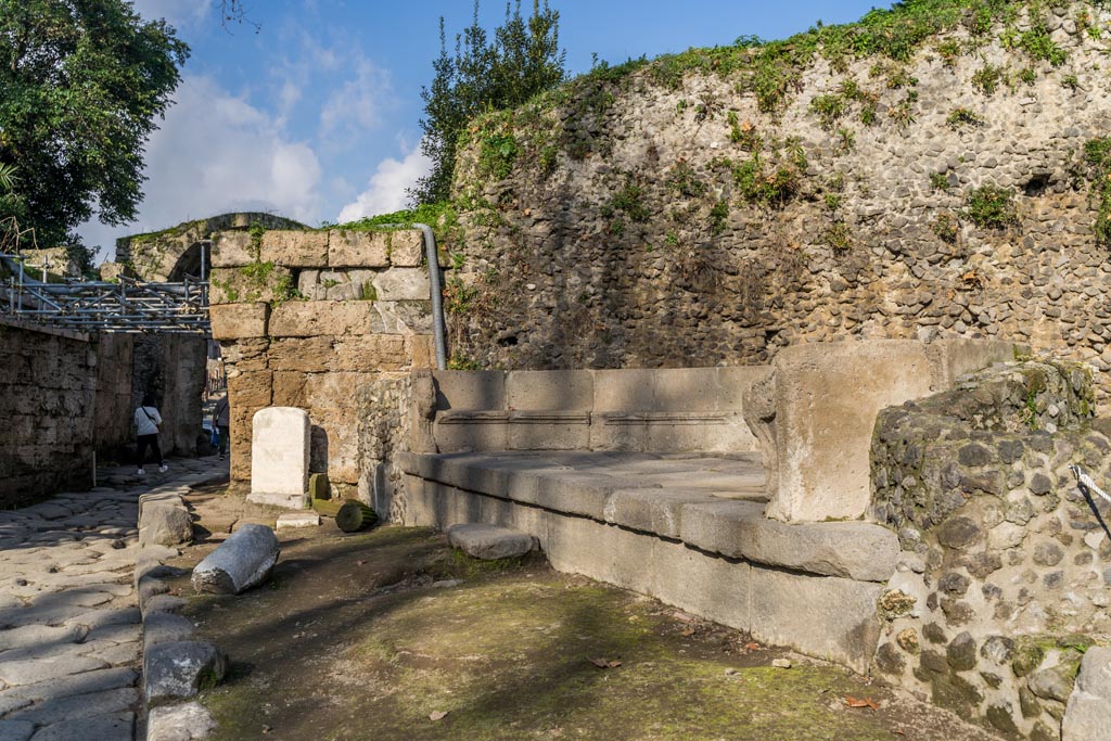 SGD Pompeii. January 2023. Looking north towards the Cippus and the schola tomb, south-east of the Stabian Gate. 
A step in front of the tomb is now visible. Photo courtesy of Johannes Eber.