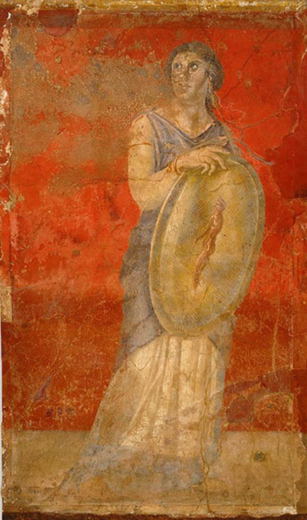 Villa of P Fannius Synistor at Boscoreale. Room H south end of east wall.
Standing woman clad in a white chiton and blue cloak, and holding a gold shield in her right hand. H
She is turning her head upwards to gaze towards the wall with Venus. 
The front of the shield shows the image of a standing nude male figure who is adorned with a white headband, the same as those worn by Hellenistic dynasts. 
This small male figure has been described as a reflected image on the shield, a popular motif in Hellenistic art. 
However, since there is no image in the fresco cycle that corresponds to a reflection, the figure should be understood as an apparition, which, in antiquity, was viewed as prophetic. 
The small apparition with a portrait like head in this particular fresco may refer to a Hellenistic royal heir, and the woman bearing the shield may represent a priestess or prophetess.
Photo  The Metropolitan Museum of Art, Rogers Fund 1903. Inventory number 03.14.7.
See www.metmuseum.org
See Barnabei F., 1901. La villa pompeiana di P. Fannio Sinistore. Roma: Accademia dei Lincei. p.57, Fig. 12.