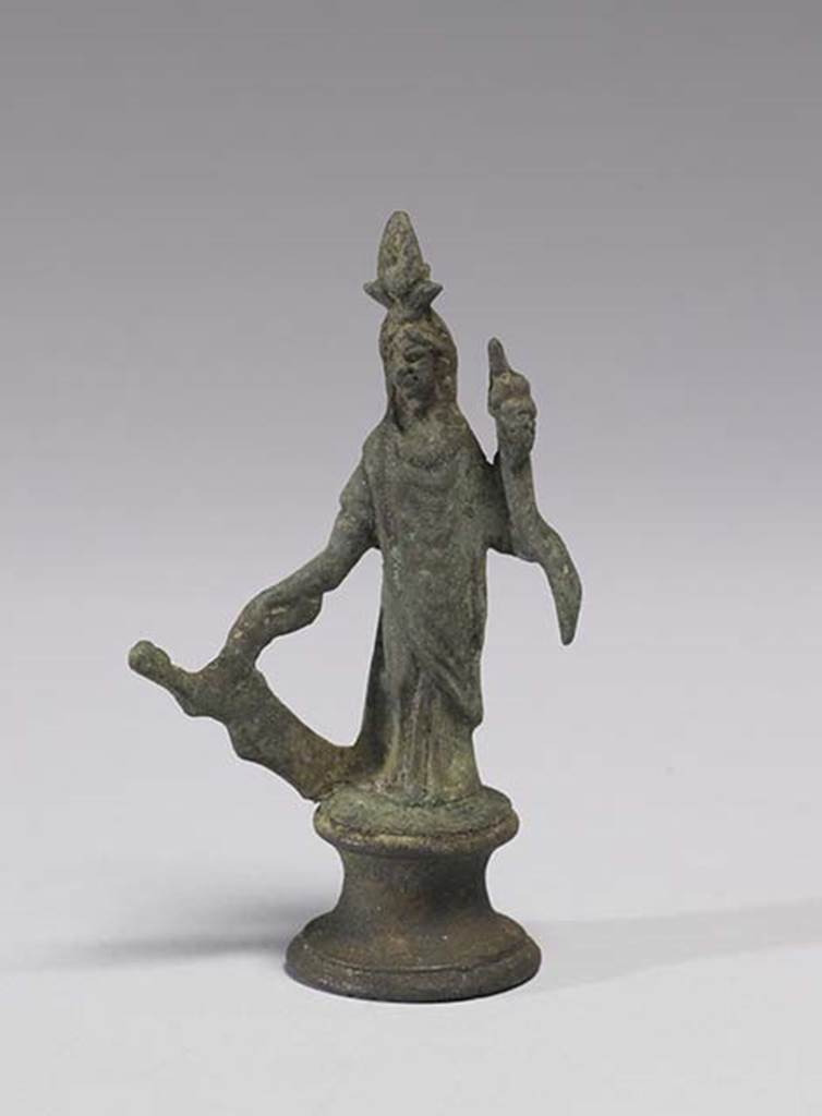 Boscoreale, Villa rustica in fondo D’Acunzo. Room 12, lararium. 
Bronze statuette of Isis-Fortuna, 0.09m high including the base, front view.
She is fully clothed and has a crescent moon and a disk surmounted by two plumes upon her forehead.
In her right hand she holds a rudder, in her left hand a cornucopia.
Photo courtesy of The Walters Art Museum, Baltimore. Inventory number 54.747.
http://thewalters.org/
Creative Commons Attribution-ShareAlike 3.0 Unported Licence
