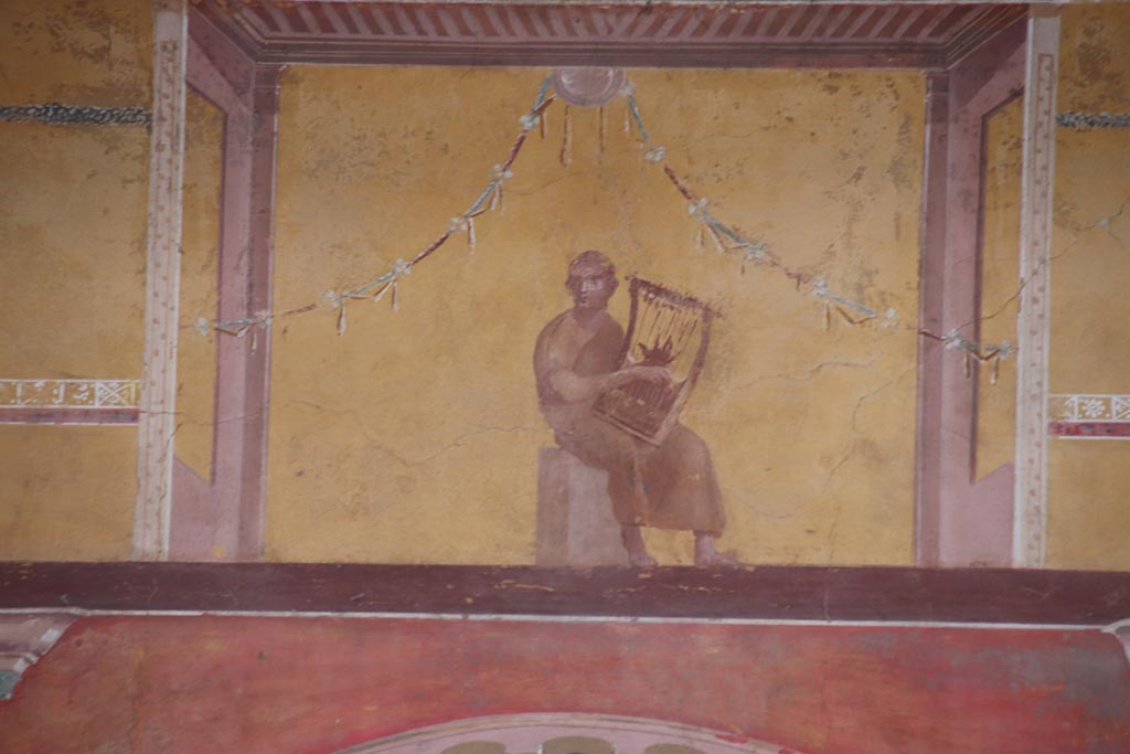 Oplontis Villa of Poppea, October 2022. 
Room 8, painted upper centre of east wall with painting of a poet playing the lyre. Photo courtesy of Klaus Heese.

