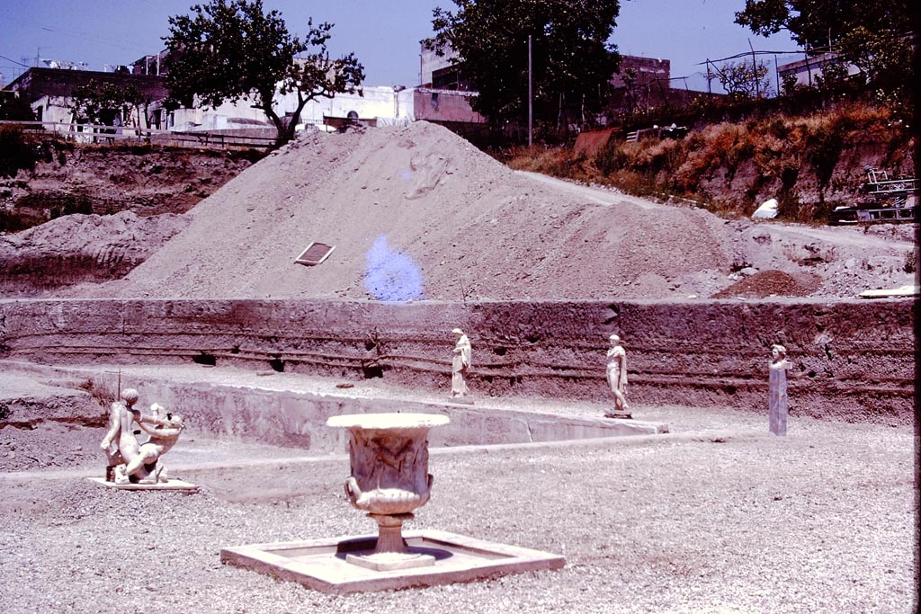 Oplontis Villa of Poppea, 1978. 
Area 98, looking north-east from terrace 92, with statues returned temporarily to their original places on east side of pool 96. Photo by Stanley A. Jashemski. 
Source: The Wilhelmina and Stanley A. Jashemski archive in the University of Maryland Library, Special Collections (See collection page) and made available under the Creative Commons Attribution-Non-Commercial License v.4. See Licence and use details.
J78f0076
