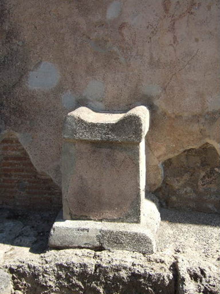 Pompeii, street altar on west side wall of I.11.1, September 2005.
According to Della Corte, found written in charcoal probably by a passer-by was CIL IV 8426:
[Per] Lares sanctos 
rogo tu et…… [CIL IV 8426]
This was written, approximately in the left top corner of the photo, although none of the wording has been conserved.
According to Cooley, CIL IV 8426, appeared to the left of a street corner shrine, where a painting of a Lar and a serpent can still be faintly seen. On top of the altar were found the carbonised remains of a sacrifice of a chicken. She translated the wording as  –
“By the sacred Lares, I ask you …..”  [CIL IV 8426]
See Cooley, A. and M.G.L., 2004. Pompeii : A Sourcebook. London : Routledge. (p.109)

