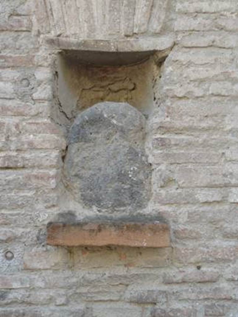 Street altar outside I.12.5, Pompeii. October 2011. 
Rectangular niche on the left side of the doorway with a blue lava stone. Photo courtesy of Daniel Genot.