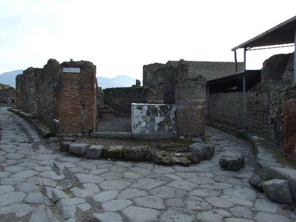 Pompeii Street Shrine at VI.4.1 at junction of Via Consolare and Vico del Farmacista. No longer visible. December 2006. Looking south.